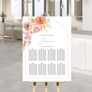 May include: A floral-themed seating chart for a baptism. The chart features a pink and orange floral design with a cross and the name "Jasmin" at the top. The chart lists tables and names for guests.