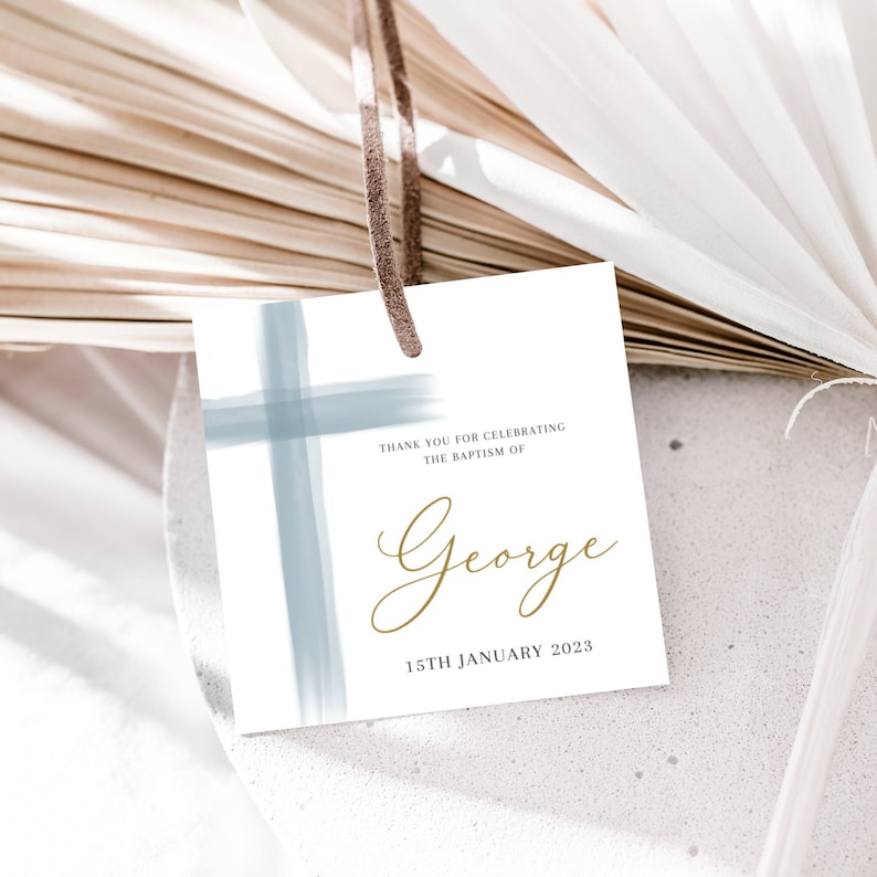 May include: White card with a blue watercolor cross and gold text. The text reads "Thank you for celebrating the baptism of George 15th January 2023".