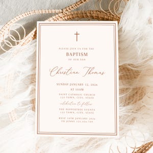 May include: A baptism invitation card with a cross at the top. The card has a cream background with a brown border and text. The text includes the words "Baptism of our son" and the name "Christian Thomas". The date and time are also included.