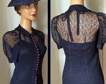 Lace blue dress with covered button closure.