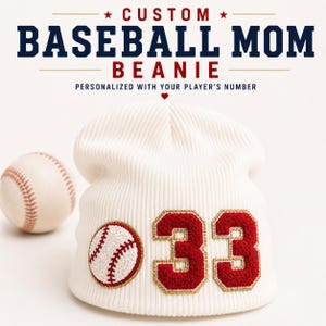 May include: A white ribbed knit beanie featuring a circular baseball patch and the number 33 in red chenille with gold trim. Text above reads: CUSTOM BASEBALL MOM BEANIE, PERSONALIZED WITH YOUR PLAYER'S NUMBER. A baseball sits to the left.