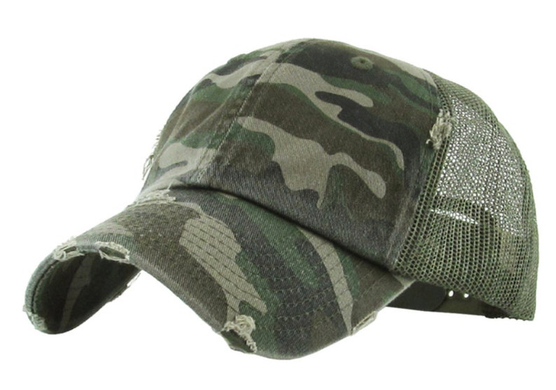 May include: Camouflage baseball cap with a distressed appearance. The cap has a curved peak and a mesh back for ventilation. The camouflage pattern features green, brown, and tan shades.