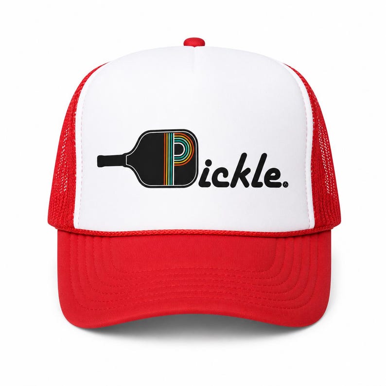 May include: A red and white trucker hat featuring a graphic of a black pickleball paddle with a rainbow-striped letter P inside the paddle head, followed by the black text pickle. The hat has a solid red brim and a white front panel.