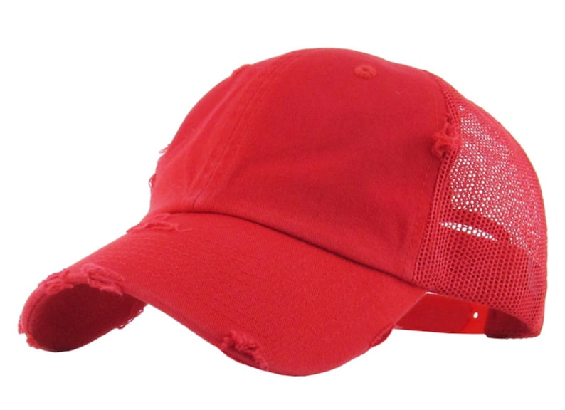 May include: A distressed red baseball cap with a curved peak and a mesh back. The cap has a worn, vintage appearance with frayed edges on the peak and crown. An adjustable strap is visible.