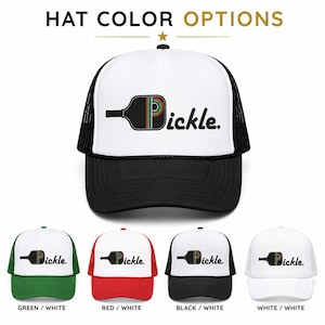 May include: A trucker hat with a white front panel and black mesh back, featuring a graphic of a pickleball paddle with a rainbow-striped letter P and the text pickle. Below are four color variations: green and white, red and white, black and white, and all white.