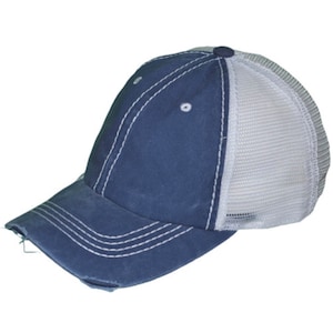 May include: A navy blue baseball cap with a white mesh back, showing signs of wear. The cap has white stitching and a pre-curved peak with a distressed edge. A small, dark blue button is on top.