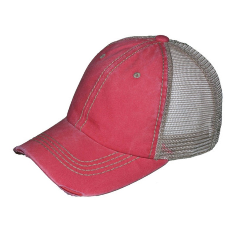 May include: A distressed red baseball cap with a mesh back. The cap has a curved peak and is stitched with beige thread. The mesh back is a light beige colour.