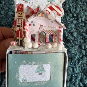 Whimsical Putz style mini winter scene with mini journal in a box under