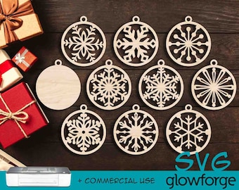 May include: Nine wooden ornaments with snowflake designs, including a blank ornament. The ornaments are arranged on a wooden surface. The text "SVG glowforge" is at the bottom of the image.