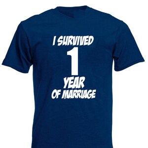 May include: A navy blue t-shirt with white text that reads "I survived 1 year of marriage".