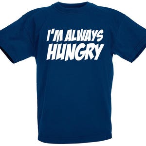 May include: A navy blue t-shirt with white text that reads "I'm Always Hungry".