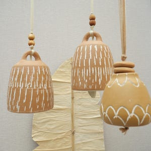 Handmade terracotta bell, rustic clay wall hanging from India, soft boho decor, artisanal ceramic accent, chime