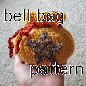 May include: A crocheted yellow bell bag with a brown star and red string. The bag is labeled "bell bag pattern".