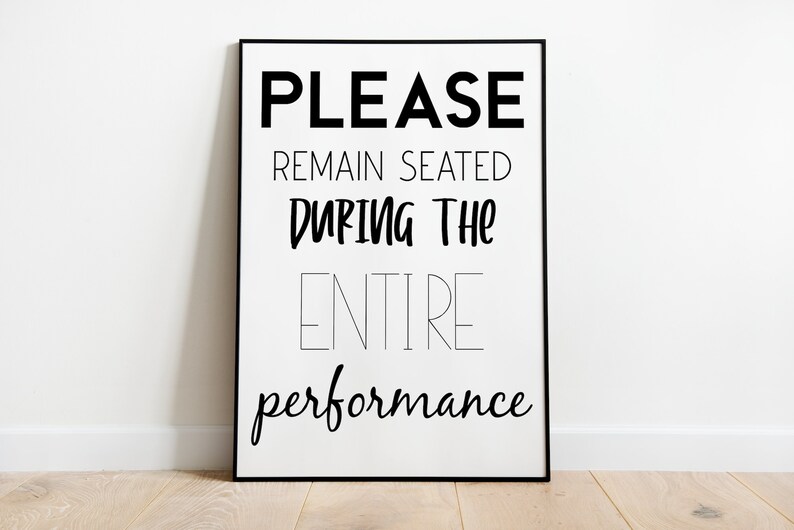 May include: Black and white framed print with the text "PLEASE REMAIN SEATED DURING THE ENTIRE performance".