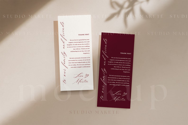 May include: Two white thank you cards with burgundy script text. The text reads "To our family and friends" and "Thank you! We are forever grateful for your support, encouragement, love and laughter. It truly means the world to us as you are here to share our wedding day with us. Thank you for celebrating in our love, love and happiness." The cards are signed "Lisa & Martin" with a small heart symbol.