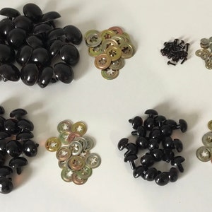 May include: Assortment of black and brown plastic safety eyes for crafts, with metal washers and screws. The eyes come in different sizes.