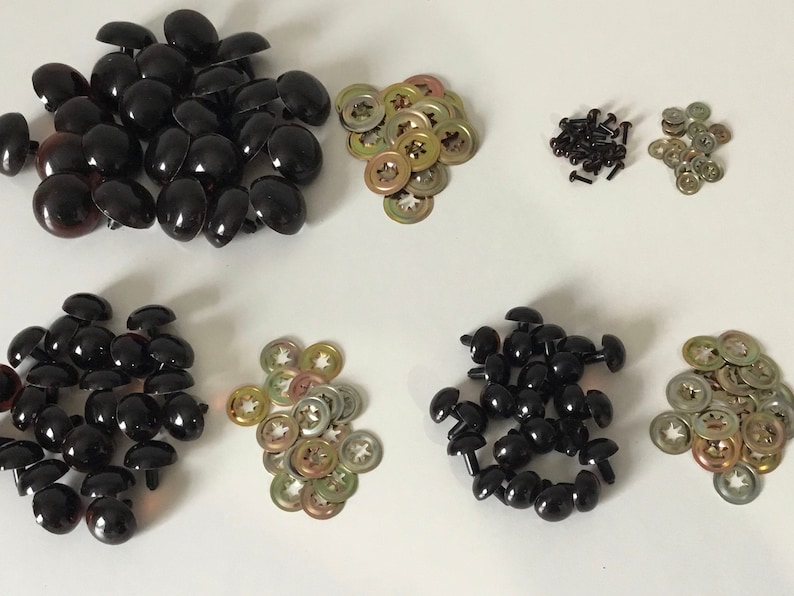 May include: Assortment of black and brown plastic safety eyes for crafts, with metal washers and screws. The eyes come in different sizes.