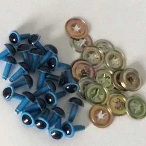 May include: A pile of blue plastic safety eyes with black pupils and metal washers. The safety eyes have a post on the back for attaching to fabric.