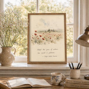May include: A framed watercolor print of a field of red poppies with a quote by Ralph Waldo Emerson. The print is displayed on a windowsill with a vase of flowers, a lamp, and a cup. The quote reads, "Adopt the pace of nature, her secret is patience."