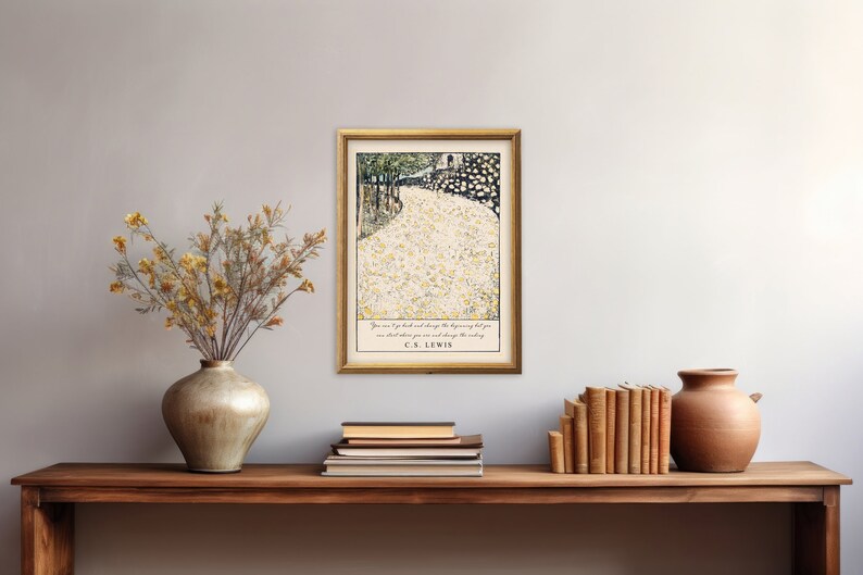 May include: A framed print with a quote by C.S. Lewis. The print features a black and white illustration of a path lined with white flowers. The quote reads "You are never too old to set another goal or to dream a new dream."