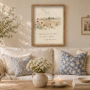 May include: A framed print with a watercolor landscape of a field of red poppies and the text "Adapt the pace of nature, her secret is patience." A small framed botanical print hangs to the right.