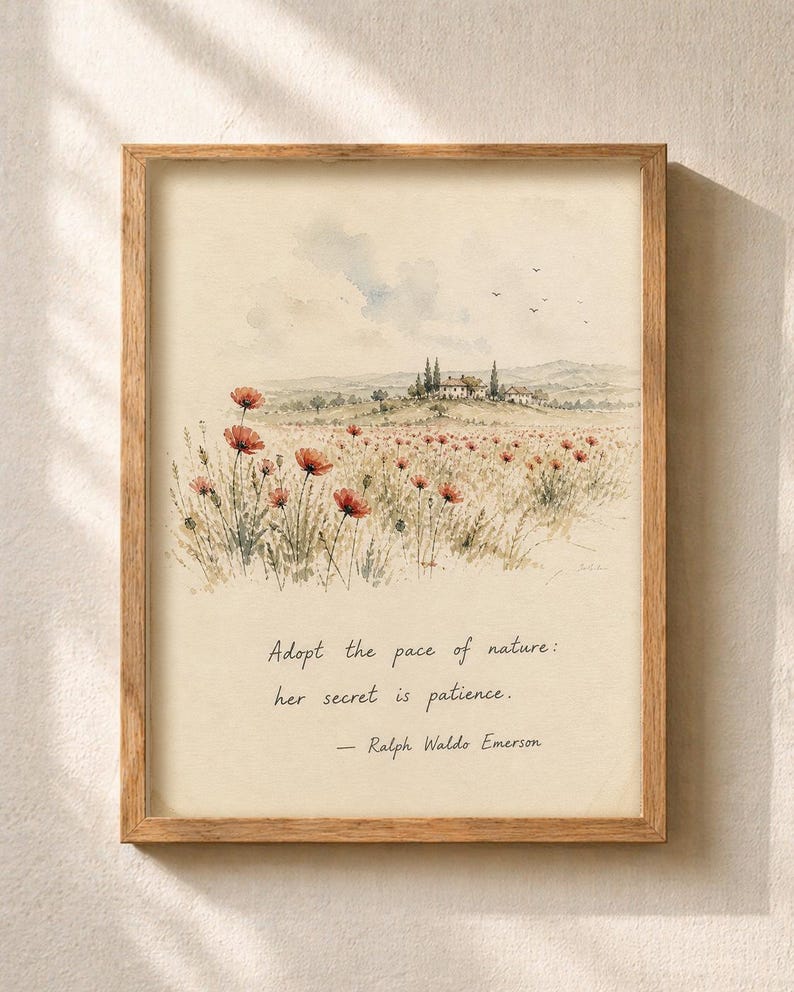 May include: A framed watercolor print featuring a field of red poppies and a distant Tuscan-style villa. The artwork includes the quote, "Adopt the pace of nature: her secret is patience." by Ralph Waldo Emerson. The frame is made of light brown wood.