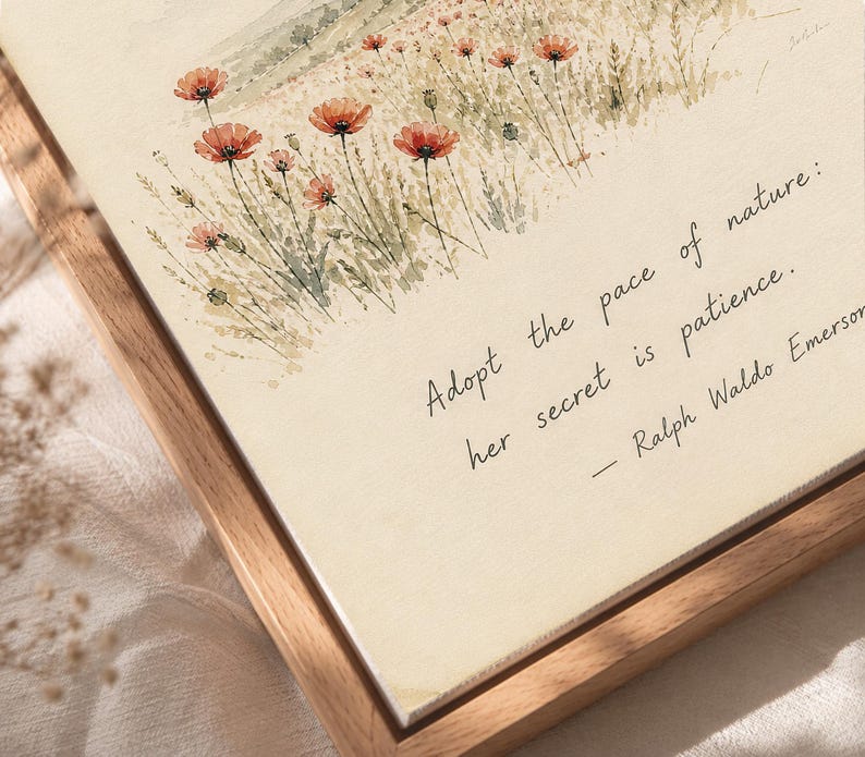 May include: A framed watercolor print featuring a field of red poppies and the quote "Adopt the pace of nature: her secret is patience." The artwork has a light beige background and a natural wood frame.