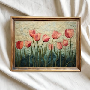 May include: A framed artwork featuring a quilted design of pink and red tulips with green stems against a light blue and green background. The artwork is enclosed in a gold-coloured wooden frame, creating a classic and elegant aesthetic.