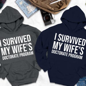 I Survived My Wife's Doctorate Program Hoodie, Gift For PHD Husband, PHD Dissertation Hoodie,Funny PHD Graduation Gift, Husband Hoodie, Gift
