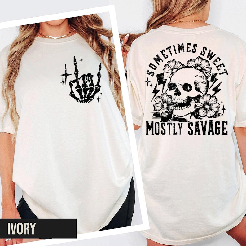 a white t-shirt with a graphic design on the back, including a skull and floral elements, along with the text "Sometimes Sweet, Mostly Savage" and " Ivory".