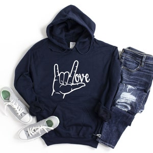 May include: Navy blue hooded sweatshirt with a white graphic of the American Sign Language symbol for "love" and the word "love" written in cursive.