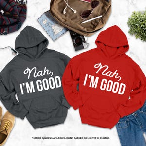 two hooded sweatshirts with the text " Nah, I'm good" printed on them, along with a pair of jeans, a pair of shoes, a backpack, and some other items.