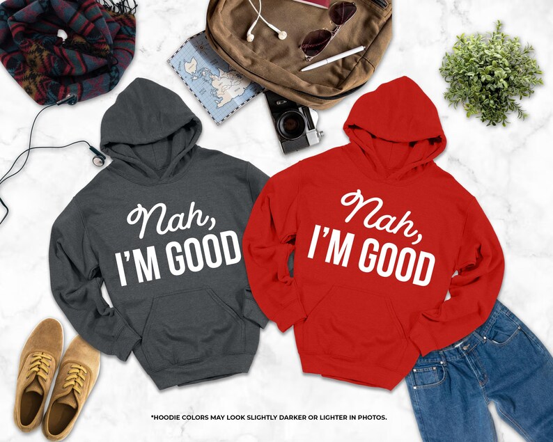 two hooded sweatshirts with the text " Nah, I'm good" printed on them, along with a pair of jeans, a pair of shoes, a backpack, and some other items.