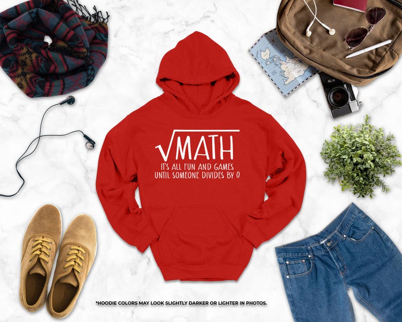 a red hoodie with a white text design, a pair of brown shoes, a pair of blue jeans, a scarf, a camera, a map, and some plants.