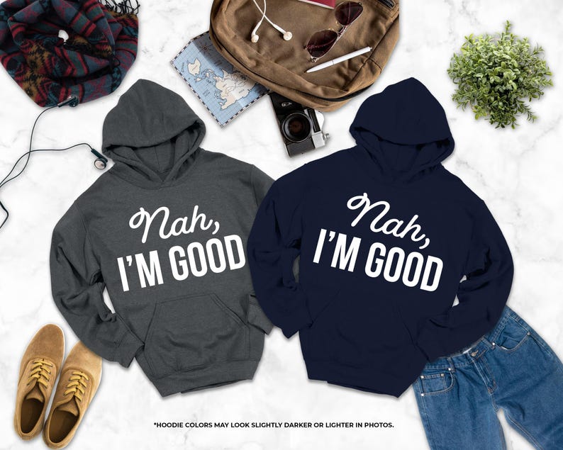 two hooded sweatshirts with the text " Nah, I'm good" printed on them, along with a pair of jeans and some other clothing items.