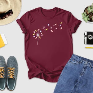 a women's t - shirt with flowers on it next to a pair of