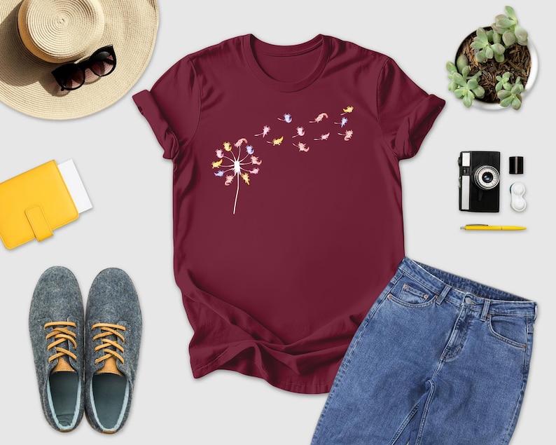 a women's t - shirt with flowers on it next to a pair of
