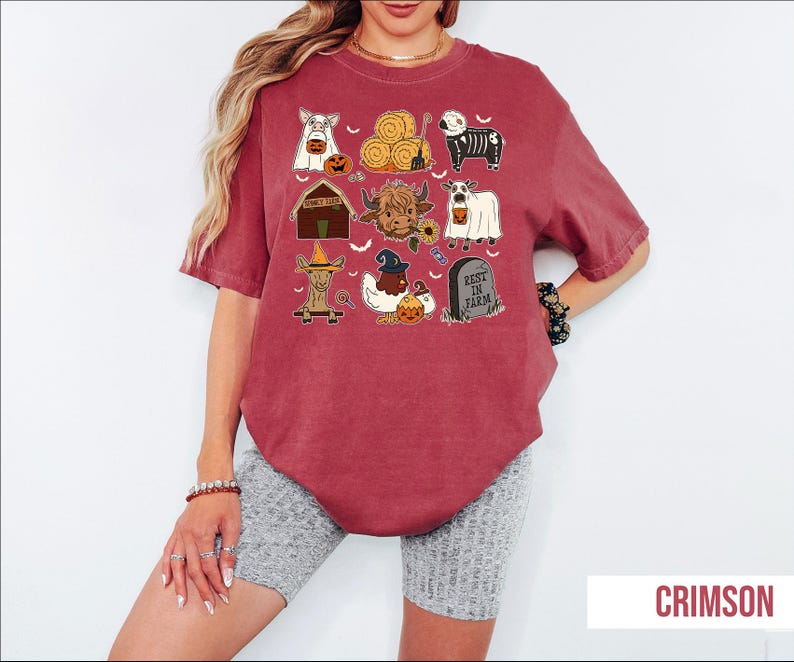 A woman wearing a red t-shirt with various Halloween-themed illustrations, including pumpkins, bats, and other spooky and festive elements.