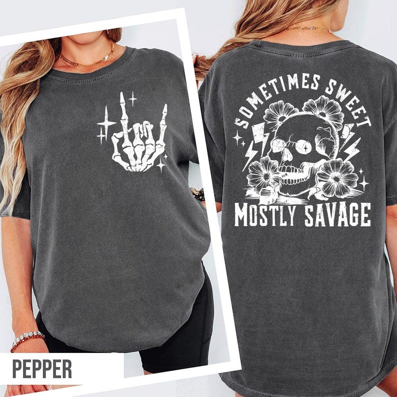 a woman wearing a gray t-shirt with a graphic design on the back. The design includes a skull, flowers, and the text "Sometimes Sweet Mostly Savage".