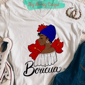 May include: White V-neck t-shirt with a graphic of a woman in a blue head wrap and red flowers, and the word "Boricua" in black script. The text "Digital Download By Artsy Coqui" is at the top.