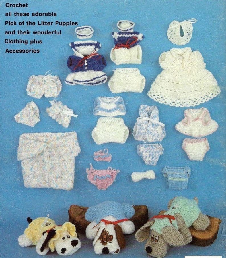 May include: Crocheted puppy dog toys with various outfits and accessories. The puppies are laying down on a wooden log. The outfits include a sailor dress, a white dress, a pink dress, and a blue and white striped dress. The accessories include a bib, a diaper, and a bone.