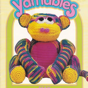 May include: Crochet pattern for a colorful monkey toy. The pattern is called "Max" and is from the Yarnables collection. The pattern is available in two yarn weights: chunky (18 inches tall) and worsted (13 inches tall).