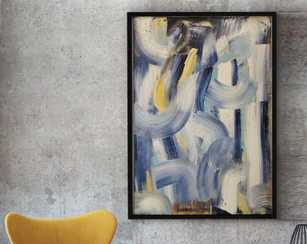 May include: A rectangular wall art piece in a black frame featuring abstract brushstrokes in shades of navy blue, light blue, white, and yellow. The artwork is displayed above a wooden console table with two yellow wingback chairs.