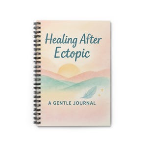 May include: Spiral-bound journal with the text "Healing After Ectopic" in teal script. The cover features a watercolor landscape with a sun, mountains, and a feather. The words "A Gentle Journal" are printed below the image.