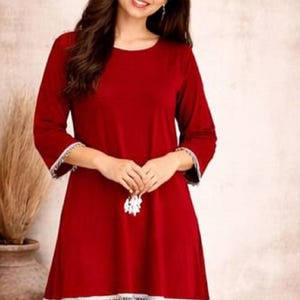 May include: A red two-piece pajama set. The top has long sleeves with white trim and a flared hem with white fringe. The matching pants are a solid red. The image includes the brand logo "SIYABUN" in the upper right corner.