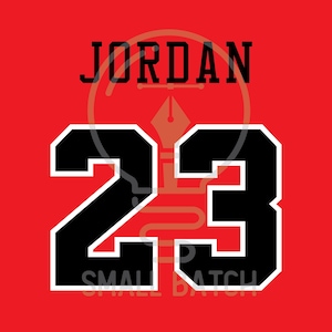 May include: Red background with the word "JORDAN" in black block letters above the number "23". The number "23" is black with a white outline. The words "SMALL BATCH" are at the bottom.