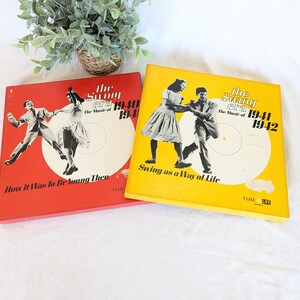 May include: Two vintage vinyl record albums from the Swing Era, 1940-1942. One album is red with a black and white image of a dancing couple and the text "How It Was To Be Young Then". The other is yellow with a dancing couple and the text "Swing as a Way of Life".
