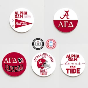 May include: Six round white and red stickers with various designs and text. The stickers feature the text "Alpha Gam Says Roll Tide", "Alpha Gam Loves the Tide", "AΓΔ", "AΓΔ♥s BAMA", "Alpha Gamma Delta Says 18 Roll Tide", and "A AΓΔ".