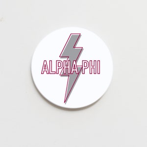 May include: White round sticker with a grey lightning bolt and the text "ALPHA-PHI" in maroon.