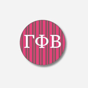 May include: A round button with a pink and gray striped background. The button features the Greek letters ΓΦB in white, centered on the design. The button has a white border and a slight shadow.